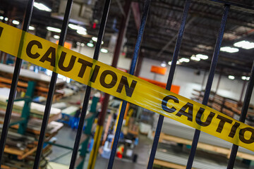 Yellow caution tape on stair metal handrails