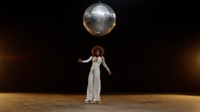 Charming African American Woman in Roller Skates Rides Around Under Disco Ball