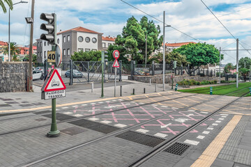 San Cristobal de La Laguna, Spain - November 24, 2021: Cityscape with tram tracks and road markings in La Laguna town on Tenerife island. Road signs with the inscription Tram Priority on a city street © ioanna_alexa