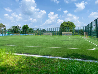 Super wide angle view of open spacious futsal field in HDB heartland in Singapore. Community football pitches in local neighbourhoods to encourage people to engage in active healthy lifestyle. - obrazy, fototapety, plakaty