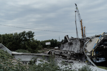 Fototapeta na wymiar Irpen, Kyiv region, Ukraine - July 15, 2022: Remains of a blown up bridge that collapsed during the Russian-Ukrainian war.