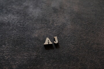The letters A and J above the dark field. Initials AJ