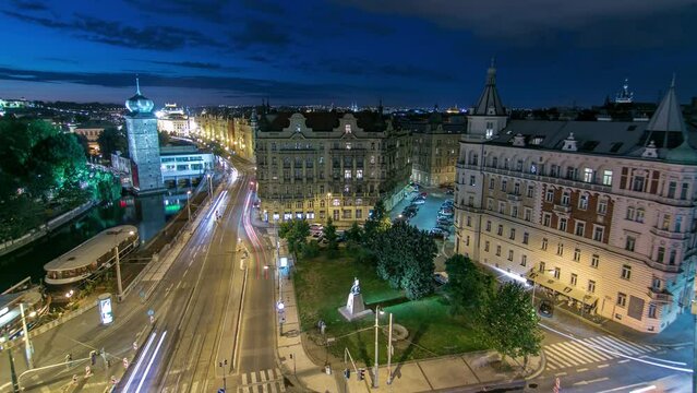Sitkovska water-tower aerial night timelapse and traffic on road in old city center of Prague. World Heritage Site of UNESCO. View from top of dancing house