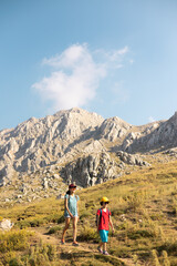 mother with a child on a hike walk along the road