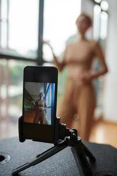 Positive creative influencer filming video for her social media and talking about new trands and techniques
