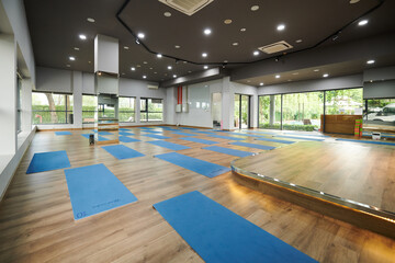 Spacious dance studio with big windows and small stage in front