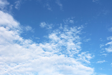 Fantastic soft white clouds against blue sky background, soft focus.