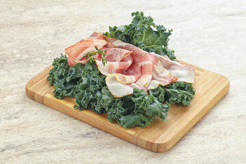 Raw pork bacon over board