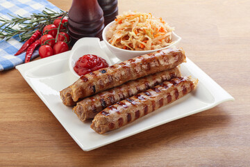 Grilled sausages with cabbage and sauce