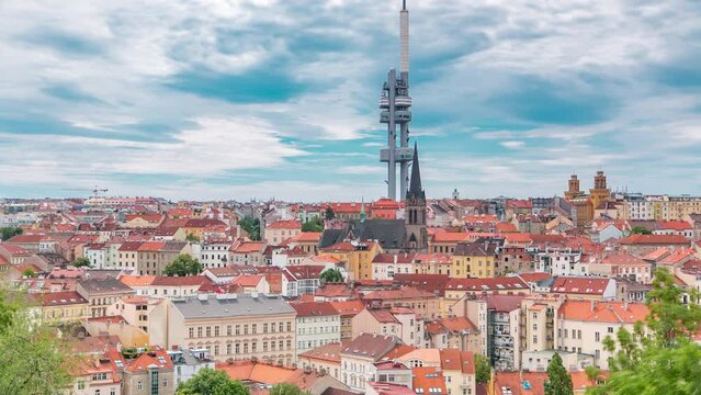 Timelapse view from the top of the Vitkov Memorial on the Prague landscape on a sunny day with the famous Zizkov TV tower on the horizon. Buildings with red roofs