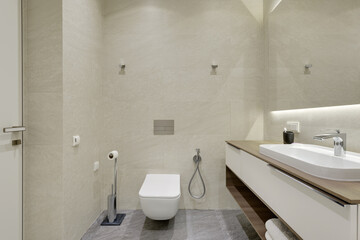 Fototapeta na wymiar bathroom with beige tiles with stone texture, modern bathroom interior