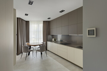 modern kitchen interior, kitchen with dining table in modern style, large modern kitchen in beige brown tones