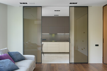 living room, sliding doors to the kitchen, modern apartment, large glass sliding doors