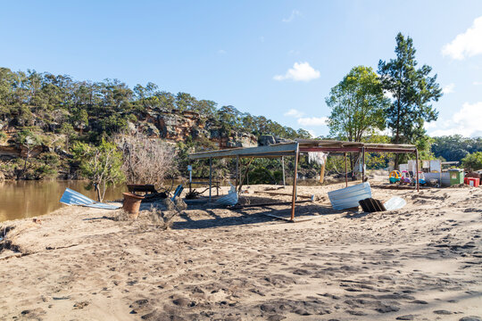 Photograph of a severely flood damaged building on the banks of the Hawkesbury river