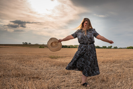 Happy and satisfied beautiful plus size model outdoor.