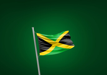 Jamaica flag waving in the wind on flagpole.