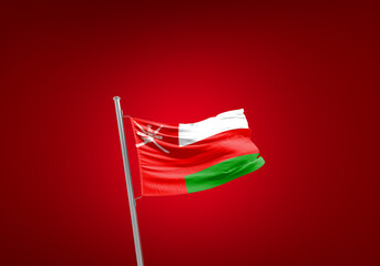 Oman flag waving in the wind on flagpole.