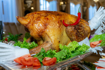 A large roast turkey on the holiday table at Thanksgiving