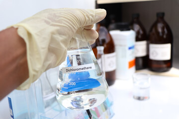Fototapeta premium Dichloromethane in glass, chemical in the laboratory