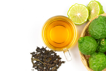 Bergamot tea in transparent cup with fresh bergamot fruit isolated on white background, top view, copy space.