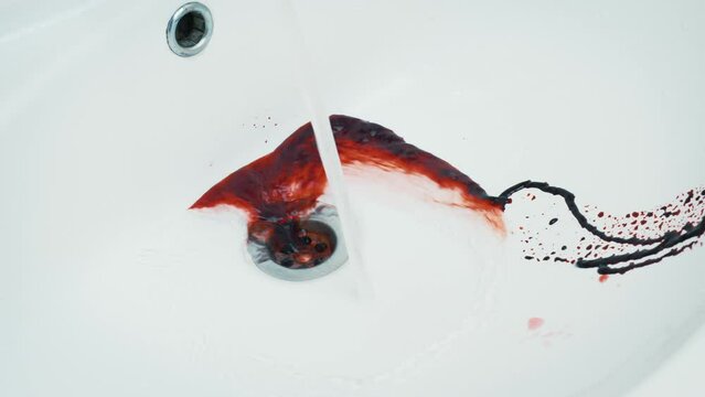 Bleeding from cuts, wounds. Blood moving in bathroom. Health risk, life danger, criminal. Jet of red liquid, paint or berries juice flowing down sink and is washed off with tap water