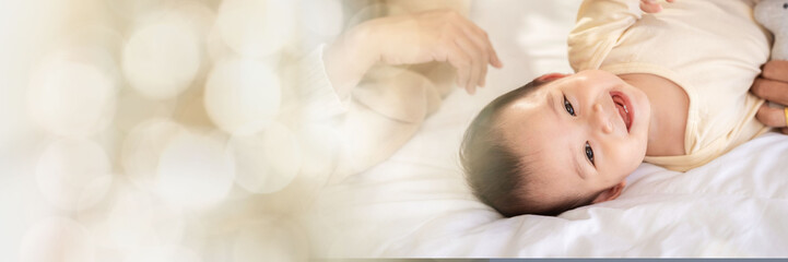 Web banner Family baby girls Asian fathers and mothers They are doing fun activities on the bed in house perfect family concept The love of fathers and mothers for their children the growth infants