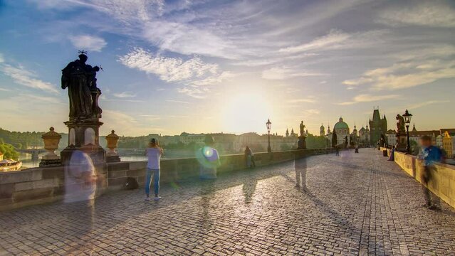 Charles Bridge in Prague during the sunrise panoramic timelapse, Bohemia, Czech Republic. Cloudy sky at morning
