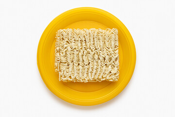 Instant noodles in a yellow, disposable plate, studio shot, retouched image.