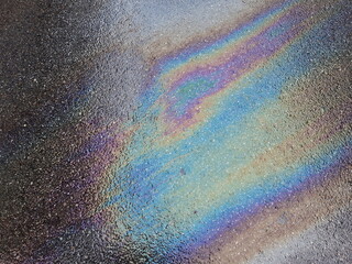 iridescent light of gasoline oil on asphalt surface texture_1