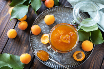 Homemade preservation. Delicious apricots jam or jelly on a rustic wooden table. View from above.