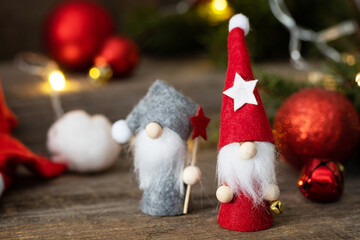Obraz na płótnie Canvas Vintage Christmas postcard design. Christmas gnomes with fir tree, christmas lights and red christmas baubles decorations.