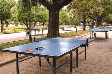 table for ping-pong, rackets, a ball for table tennis lie on the table. Street activity, hlbbi, sport