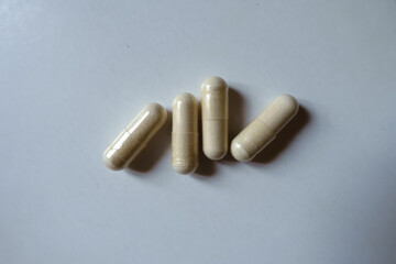 Group of four light beige capsules of Saccharomyces boulardii probiotic