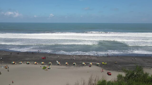 Aerial view of people holiday in parangtritis beach, Indonesia