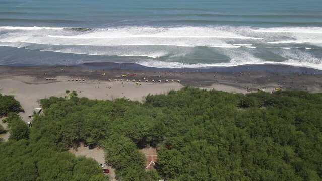 Aerial view of people holiday in parangtritis beach, Indonesia