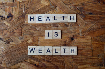 health is wealth text on wooden square, inspiration and motivation quotes