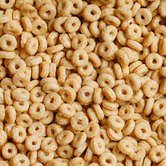 Cornflakes rings close-up square background.