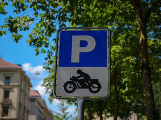 Sign for a motorcycle parking area over city street Basel.