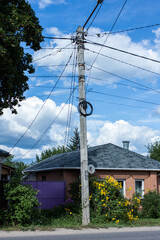 Power pole near a brick house