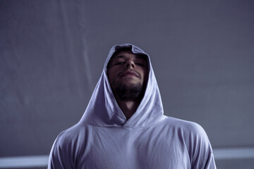 anonymous person in the night with face under the hood