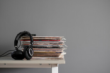 vinyl music records stack on the shelf with headphones on top - Powered by Adobe