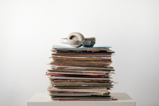 vinyl music records stack on the shelf with headphones on top