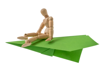 Wooden mannequin flying on a green plane