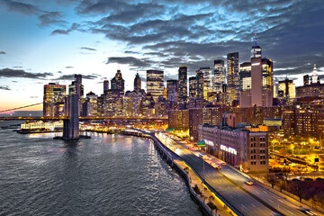 Skyline of New York City downtown and Brooklyn bridge dusk view
