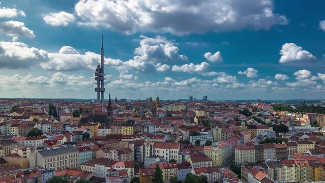 Timelapse view from the top of the Vitkov Memorial on the Prague landscape on a sunny day with the famous Zizkov TV tower on the horizon. Buildings with red roofs