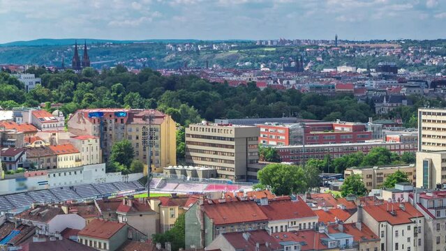 Panoramic view of Prague timelapse from the top of the Vitkov Memorial, Czech Republic. Old Town with red roofs and Vysehrad. Cloudy sky at summer day