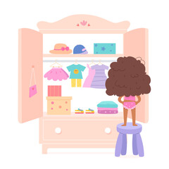 Cute girl choosing dress for fashion outfit in wardrobe, kid standing on stool with back