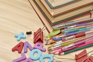 letters books pencils fountain pens brushes stationery clips on the table concept education business science