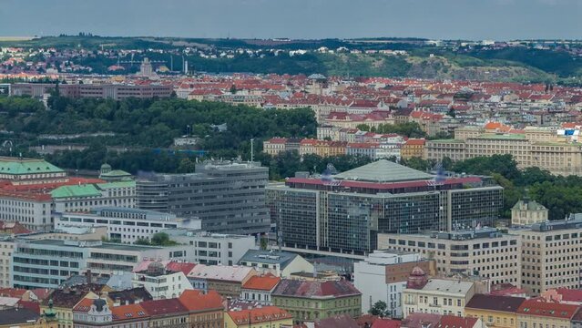 Panoramic view of Prague timelapse from the top of the Vitkov Memorial, Czech Republic. Old Town with red roofs and modern buildings. Cloudy sky at summer day