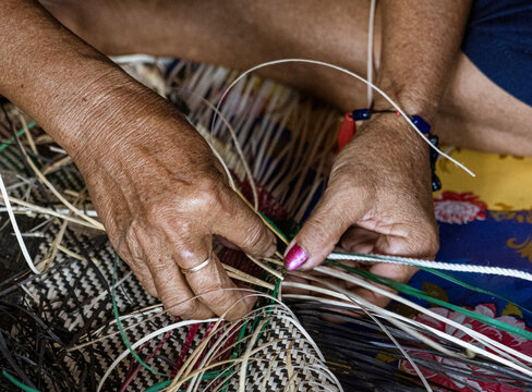 Central Kalamantan, Indonesia; May 20, 2022 - Woman makes baskets by hand.